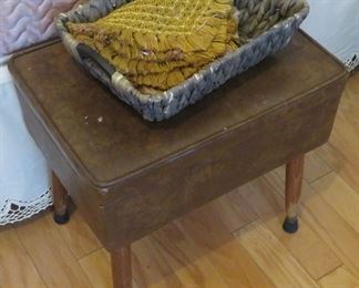 Vintage stool with storage, typically used with sewing machine.