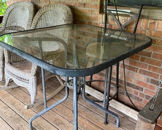 Glass top table and one metal chair 