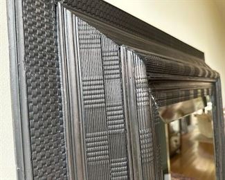 $800 An ebonised carved mirror late 19th C.