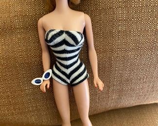 Vintage Barbie #4 Titan Ponytail, Wearing Black/White Swimsuit, Black Mules, With Sunglasses. Also there are her original Pearl Earrings. Excellent Red/Toes/Nails. Face Paint