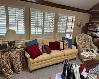 Yellow sofa 
Wicker chair and ottoman 
Paisley print 