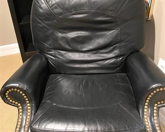 Black leather armchair with brass hobnailing