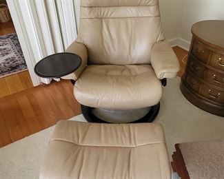This is a vintage Stressless chair and foot stool with table 