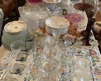 China from Austria, glass dessert plates, glass dinner, etched vintage stemware, purple glass candle stick holders, glass punch bowels and punch cups.  Vintage glass vases.