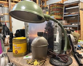 Vintage items: tobacco tins, canteen,  milk crate, and goose neck lamp. 