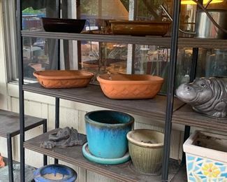 variety of pottery planters, metal shelves