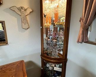 Corner Curio Rounded Cabinet w/ glass door & glass shelving (Items in cabinet sold separately, not included).