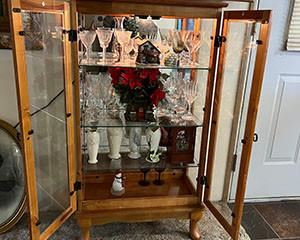 Curio Cabinet w/ glass shelves and lights. Itmes in cabinet not included and sold separately.