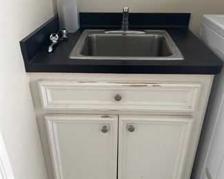 Laundry room sink and cabinet 

NO WASHER AND DRYER AVAIL