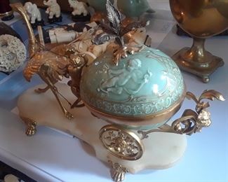 Beautiful bronze dore ostrich pulling a porcelain cart. Mounted on marble stand with ormolu feet.