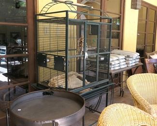 Large birdcage on stand. Large metal serving table.