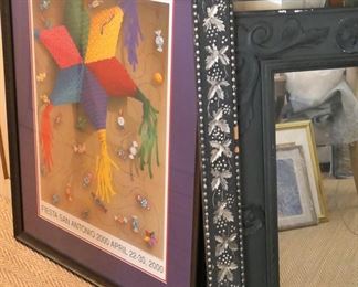 One of two framed Fiesta posters, Large black frame with silver grape leaf design, and a medium size mirror with black wood frame.