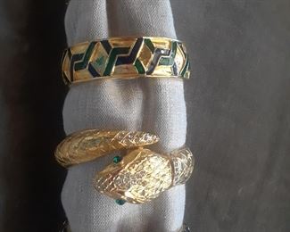 Four bracelet watches. Each conceals a watch dial but appears to be a bracelet.