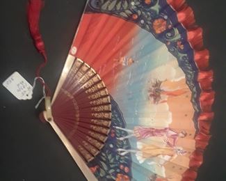 Art Deco fan with flirty scene or each side, and fluttery red fringe on the top edge of the leaf.