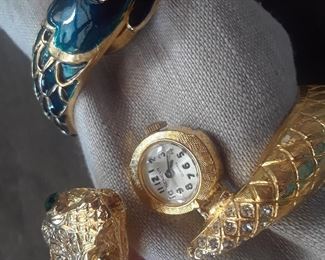 One watch bracelet shown open to reveal the concealed dial.