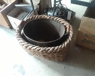 Large rope basked and copper pot waiting for firewood or plants.