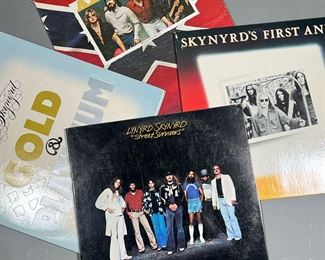 (4PC) LYNYRD SKYNYRD & OTHER | Vinyl record albums, including:
Alabama "Mountain Music"
Lynyrd Skynyrd "Gold & Platinum"
Skynyrd's First And... Last.
Lynyrd Skynyrd "Street Summons"