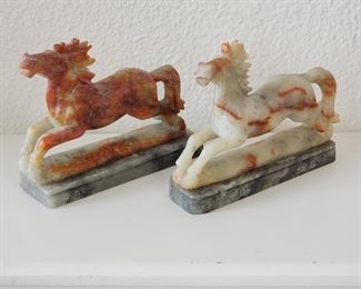 Stone horses on marble bases