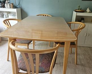 Dining table with center self storing leave