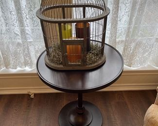 decorative bird cage on round side table