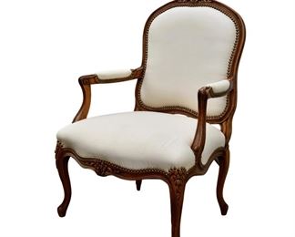 A pair of cream leather Louis XV French armchairs 