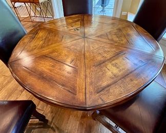 Custom Table made by Design Master. Table expands fro 54" Round to 70" Round plus total of 6 Custom Made Leather Chairs with Nail Head Trim. Looks like Brand New.