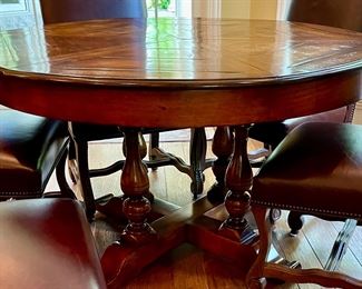 Custom Table made by Design Master. Table expands fro 54" Round to 70" Round plus total of 6 Custom Made Leather Chairs with Nail Head Trim. Looks like Brand New.