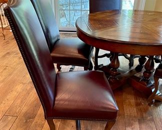 Custom Table made by Design Master. Table expands fro 54" Round to 70" Round plus total of 6 Custom Made Leather Chairs with Nail Head Trim. Looks like Brand New.
