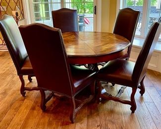 Custom Table made by Design Master. Table expands fro 54" Round to 70" Round plus total of 6 Custom Made Leather Chairs with Nail Head Trim. Looks like Brand New.