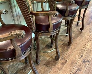 4 Custom Made Bar Stools with Leather Seats and Upholstered Backs. These are 32" H (Bar Height) to the Seat X 24" W x 24.5" D. One of them does have missing screw for one of the arms.