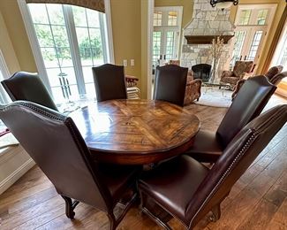 Custom Table made by Design Master. Table expands fro 54" Round to 70" Round plus total of 6 Custom Made Leather Chairs with Nail Head Trim. Looks like Brand New.