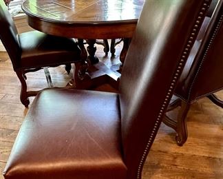 Custom Table made by Design Master. Table expands fro 54" Round to 70" Round plus total of 6 Custom Made Leather Chairs with Nail Head Trim. Looks like Brand New.