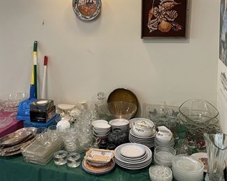 Notice the plate and the other framed art on the wall in addition to the dishware on the table.