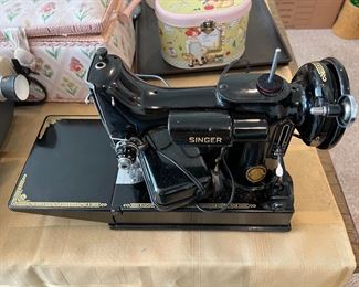 This is the vintage Singer sewing machine. Yes, it is electric. Notice the footpedal switch.