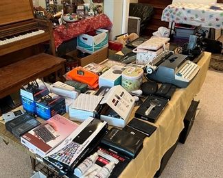 There is a typewriter on the table, and at least the box for the HP-12C financial calculator on the near end.