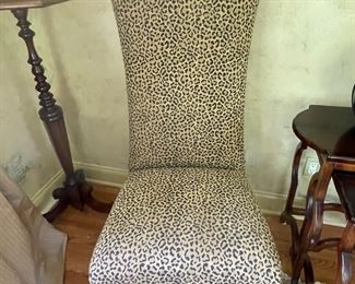 Set of two leopard high back chairs with carved legs.  