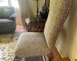 Set of two leopard high back chairs with carved legs.  