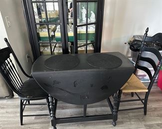 Drop leaf black table with 2 mismatched chairs