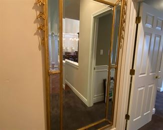 Continental Adam-style carved giltwood Pier Mirror. The scrolling crest is centered by a stylized urn, leafy pendants adorning the sides, and the central beveled plate is bordered by eight beveled plates.