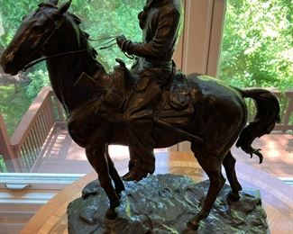 Bronze statue inspired by Frederic Remington. A Ranch Hand signed, "Inspired by Frederic Remington/copyright Henry Bonnard Bronze Co. 1895" (stamped 34)