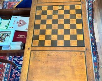 Antique game table with swivel checkerboard top. Opens to green felt card table.