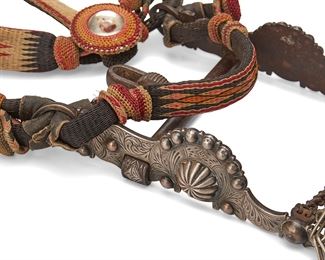 1018
20th century
A Horsehair Parade Bridle
The polychrome woven headstall with chased metal bit, inset resin medallions with dog's heads and tiger's heads, and adjustable tasseled reins, together with a conformingly designed horsehair crop, 2 pieces
Crown: 47" L; nose band: 10" L; throat latch: 19.5" L; chin strap: 7" L; reins: 66" L; crop including strap: 44" L
Estimate: $2,000 - $3,000