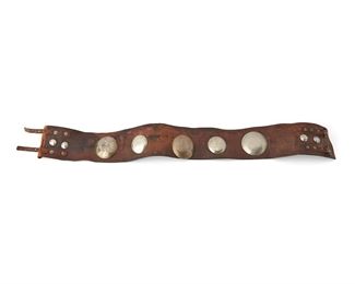 1026
19th century
A Plains Leather Concho Belt
Appears unmarked
With nine German silver smooth domed conchos in various sizes applied to a wide incised leather belt with two small riveted straps and buckles
Conchos: 2.5" Dia.; 2" Dia.; 0.75" Dia.; Belt: 32.625" L x 3.35" H
Estimate: $600 - $800