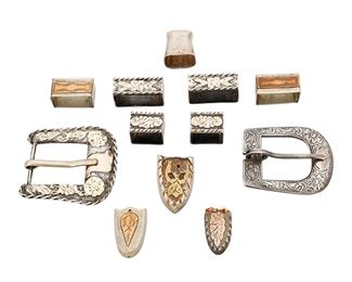 1027
Mid/late 20th century
A Group Of Ranger Set Belt Buckle Items
Variously marked: Hecho en Mexico / Sterling / 925 / 18K
Six works including a Mexican chased sterling silver and 18k gold overlay Ranger set with a buckle (1.875" H x 2" W) and two keepers (1.125" H), as well as a second chased sterling silver buckle (1.625" H x 2" W), as well as two partial Ranger sets, each with two silver and mixed metal keepers and a matching end (larger: 0.875" H; smaller: 0.75" H), and an additional mismatched keeper and belt end, 12 pieces
122.2 grams gross
Estimate: $200 - $400