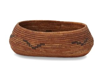 1048
Late 19th century; Northern California
A Pomo Gift Basket
A coiled oval form basket with five floating stepped motifs to sides and one end
2.75" H x 7.5" W x 4.5" D
Estimate: $500 - $700