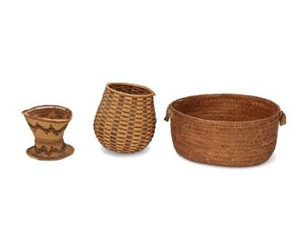 1050
Early/mid-20th century
A Group Of Baskets
A mixed group including a large coiled oval basket with hide leather handles to the side ends (7.5" H x 15" W x 13" D), a Northern California vase form basket with flared base (6.125" H x 7" Dia.), and a rounded form woven basket with rattan strips and plaited strips woven over wide bark splints, with a nailed rattan rim (9" H x 8.5" Dia.), 3 pieces
Estimate: $100 - $200