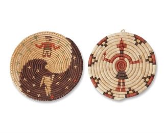 1052
Mid/late 20th century
Two Southwest Basketry Items
Two works:
Attributed to Mary Holiday Black (b. 1934, Diné)
A coiled polychrome Navajo wedding basket
A coiled "Night and Day" wedding tray basket with a standing figure on a natural pale field opposite a howling coyote figure on a dark field, each with all-over multicolored cross star motifs
2" H x 11.5" Dia.
A polychrome Hopi basketry plaque
A coiled Hopi plaque with Mud Head figure and stepped edge motifs, with hanging loop
1" H x 10.75" Dia.
2 pieces
Estimate: $400 - $600