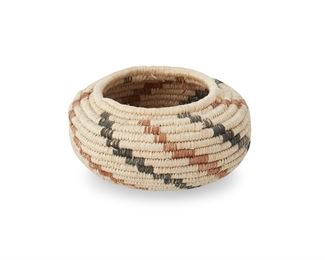 1053
Mid/late 20th century; Mexico
A Miniature Basket
A diminutive polychrome coiled basket with swirled diagonal banding from rim to base
1.375" H x 2.5" Dia.
Estimate: $50 - $75