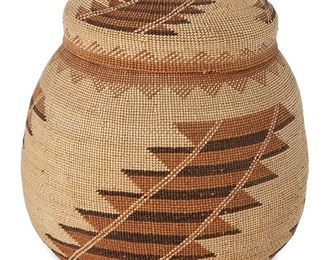 1051
Late 19th/early 20th century; Northern California
A Hupa/Yurok/Karuk Lidded Basket
A polychrome twined lidded basketry bowl in a rounded shape with three swirling sawtooth 'house ladder' style columns and with a domed lid with finial similarly decorated
8" H (with lid) x 7.5" Dia.
Estimate: $600 - $800