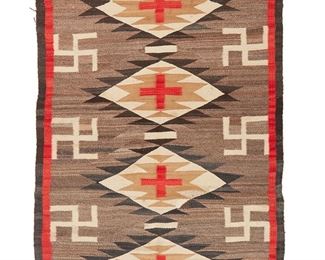 1054
Early 20th century, Diné
A Navajo Regional Rug
Woven in red, brown, cream, tan, and natural grey/brown wool, with three stacked diamonds and columns of whirling logs all within a double border of black and red
80" H x 47" W
Estimate: $800 - $1,200